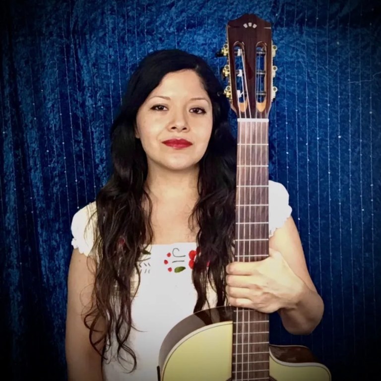 Claudia Garcia with acoustic guitar