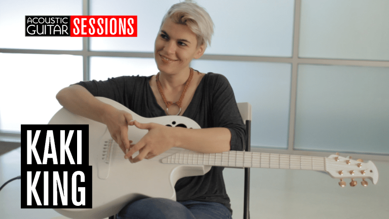 Kaki King seated with her white Ovation guitar
